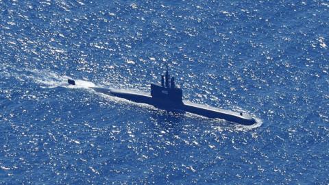 An aerial photo taken from a maritime patrol aircraft of 800 Air Squadron of the 2nd Air Wing of Naval Aviation Center (PUSPENERBAL), shows Indonesian Navy submarine KRI Alugoro sailing on a search mission for KRI Nanggala