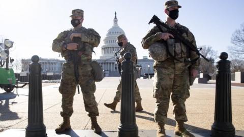 Members of the National Guard stand at the East Front of the US Capitol in Washington, DC