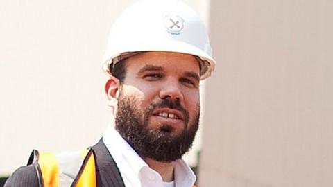 Dan Gertler wearing a hard hat