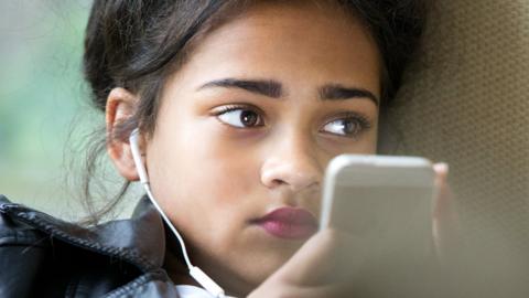 Teenage girl looking at phone