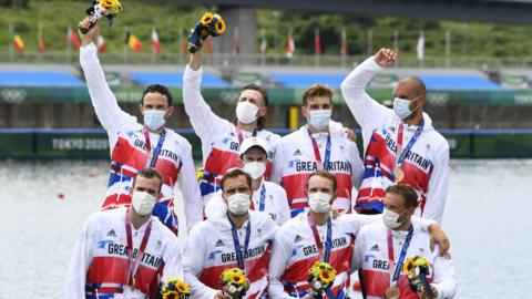 Ollie Wynne-Griffith and the GB men's eight celebrate their bronze