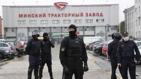 Belarus riot policemen (OMON) stand in front of the Minsk Tractor Plant to prevent any rally or attempt to organize a strike in Minsk, Belarus, 19 August 2020.