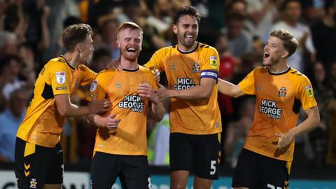 Cambridge celebrate taking the lead against Millwall