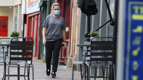 Woman with mask in the street