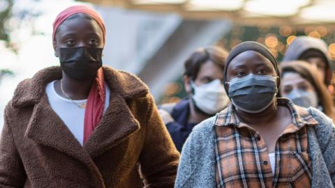 People wearing facemasks on a street in London