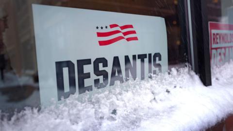 A campaign sign sits in the window as Republican presidential candidate Florida Governor Ron DeSantis speaks to Northside Conservative Club members