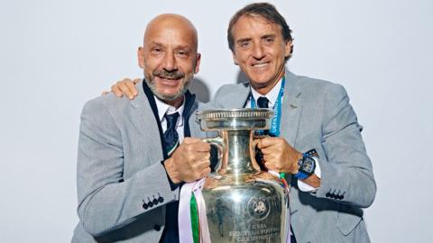 Italy coaches Gianluca Villa (left) and Roberto Mancini (right) pose with the Euro 2020 trophy