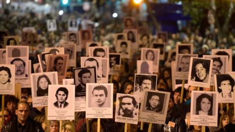 People take part in the 22th March of Silence in memory of people who went missing during the military dictatorship (1973-1985), in Montevideo on May 20, 2017