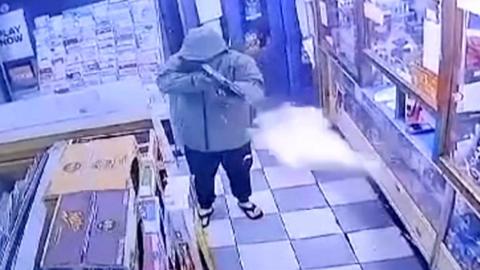 Man with gun in newsagents