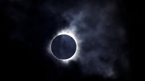 A solar eclipse is seen through the clouds on April 8, 2024 in Niagara Falls