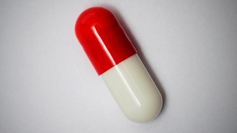 Stock image of a red and white pill