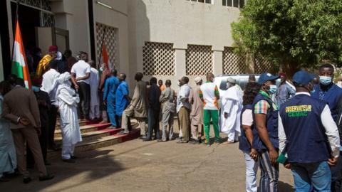 Voters queue at a polling station during the second round of the country"s presidential election, in Niamey, Niger February 21, 2021.