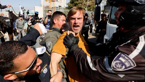 A man is detained by Israeli police during a protest against the government's contentious judicial reforms, in Tel Aviv, Israel (1 March 2023)