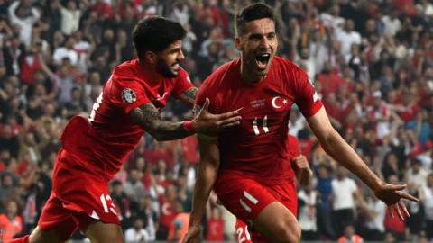 Mehmet Umut Nayir (right) celebrates with team-mate Turkey's defender Eren Elamli
