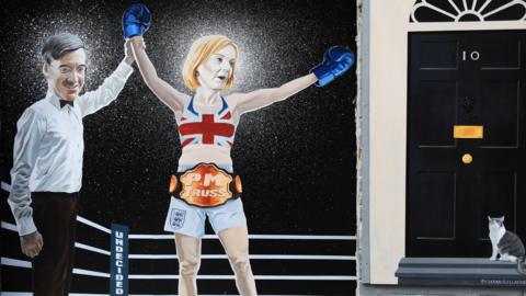 A mural in Belfast, depicting Liz Truss as a boxer who has won a fight - the mural features an illustration of Jacob Rees-Mogg, dressed as a referee, holding her arm aloft