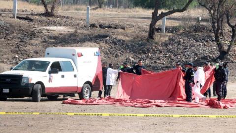 Forensic experts and members of the National Guard work in the area where a hot air balloon caught fire and collapsed in the municipality of San Juan Teotihuacan, in the State of Mexico, Mexico, 01 April 2023.