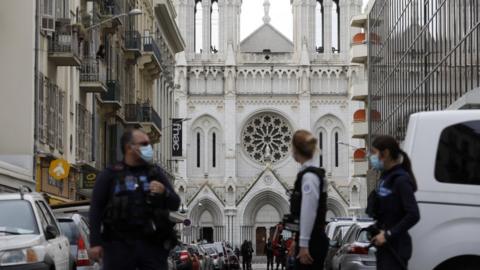 French police officers secure a street near the entrance to the church