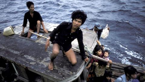 Refugees from Vietnam escaping the war-torn country by boat in 1982 pictured on the South China Sea