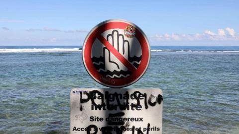 A file photo taken on 25 February, 2010, shows a sign banning swimming at Saint-Leu, on the Indian Ocean island of Reunion