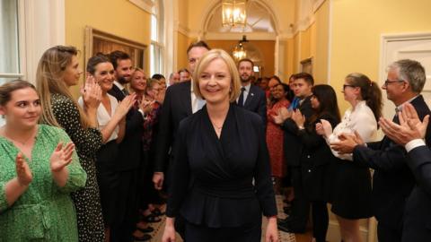 Liz Truss applauded as she enters No 10