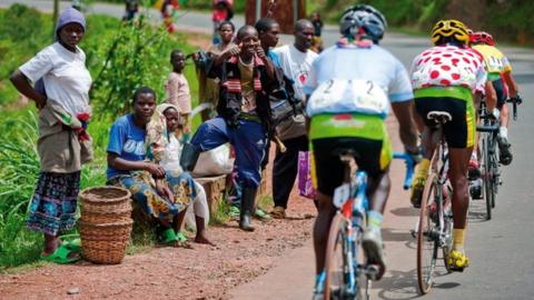 Spectators cheer on cyclists during the 2009 Tour of Rwanda