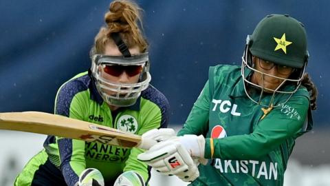 Ireland's Mary Waldron is poised as Pakistan batter Muneeba Ali plays a shot