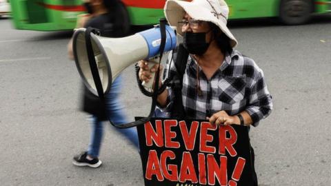 A protester holds a sign during a rally in symbolic remembrance of victims and continued opposition to Martial Law in Quezon City, Metro Manlia, Philippines 21 September 2022