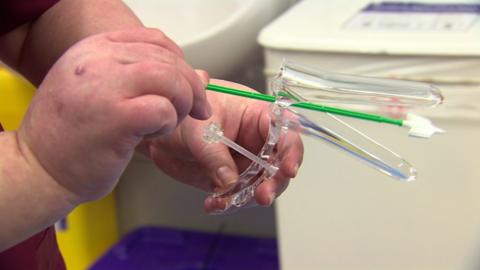 A nurse demonstrating a cervical smear test