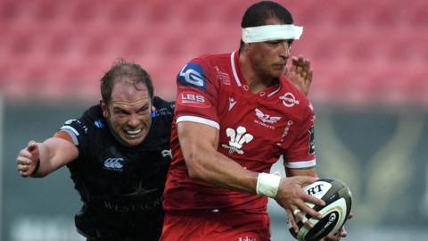 Aaron Shingler of Scarlets is tackled by Alun Wyn Jones of Ospreys