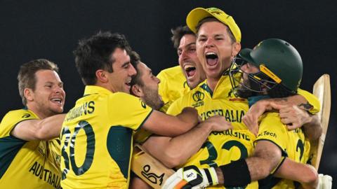 Australia plays celebrate victory over India in the 2023 Cricket World Cup final in Ahmedabad