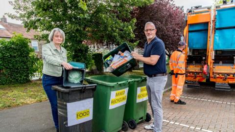 Council leaders help out with collecting garden waste bins