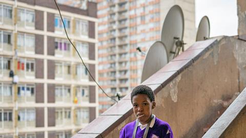 A child walks down the stairs of a hijacked building in Berea, Johannesburg, South Africa - May 2023