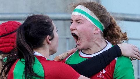 Ruth Campbell celebrates scoring a try for Clovers against Brython Thunder