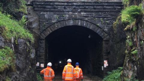 Workers entering tunnel