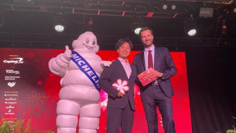 Chef Ryusuke Nakagawa from Toronto Japanese restaurant Aburi Hana posing with the Michelin man.
