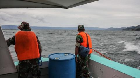 An Indonesian search-and-rescue team looks for victims of a sunken ferry on Lake Toba in Indonesia, 19 June 2018