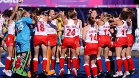England women's hockey team celebrate winning the gold medal