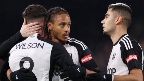 Bobby Reid of Fulham celebrates with teammates Harry Wilson and Andreas Pereira after scoring their team's first goal during the Emirates FA Cup Third Round match between Fulham and Rotherham United at Craven Cottage on January 05, 2024 in London, England.