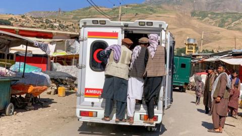Relatives carry the bodies of slain victims in an ambulance after an explosion at the Nabawi mosque in Faizabad district, Badakhshan province