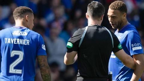 Rangers' James Tavernier and Cyriel Dessers question referee Don Robertson