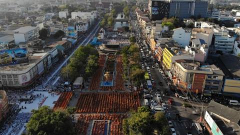 Buddhist monks gather for a mass prayer one week after a lone soldier shot and killed 29 people in Thailand