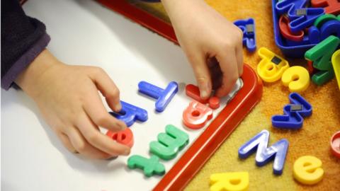 Child playing with letters