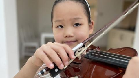 Yanran, age 7, playing violin