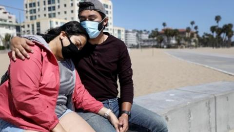 A couple in California wear face masks