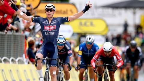 Tim Merlier celebrates as he wins the third stage of the Tour de France