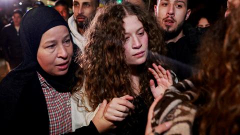 Palestinian activist Ahed Tamimi is pictured with her mother after being returned to the West Bank