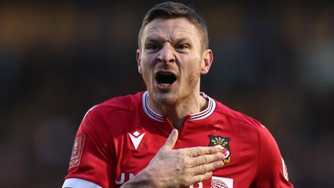 Paul Mullin celebrates after scoring a goal for Wrexham