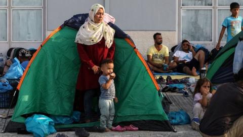 Migrants near burnt-out Moria camp, 16 Sep 20