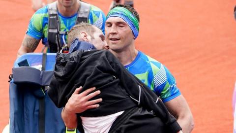 Kevin Sinfield carries Rob Burrow