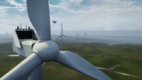 A drone flies next to a simulated wind turbine
